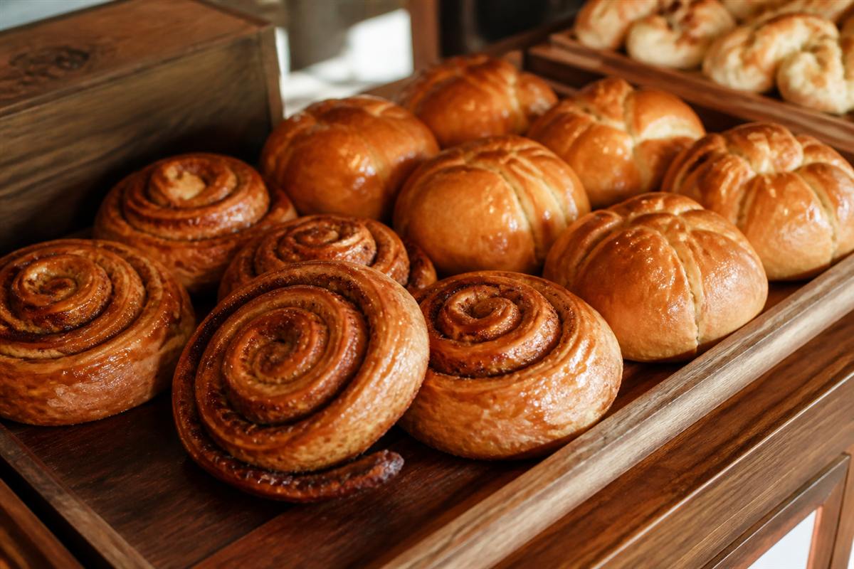 Golden bakery pastries arranged on wooden trays